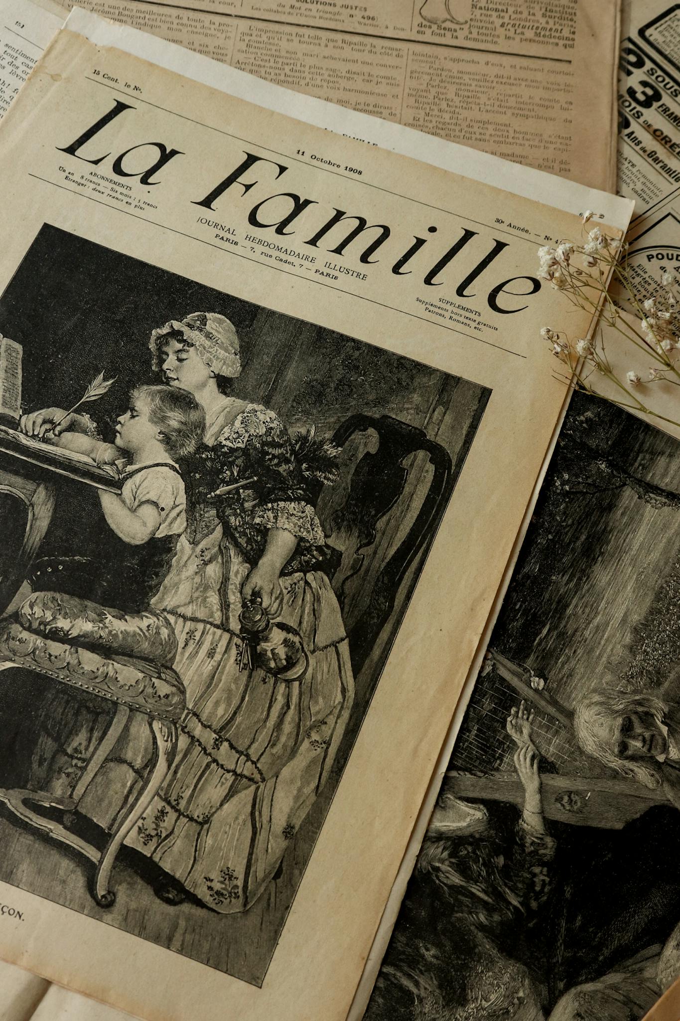Artistic shot of vintage newspaper 'La Famille' with classic illustrations. Perfect for history enthusiasts.